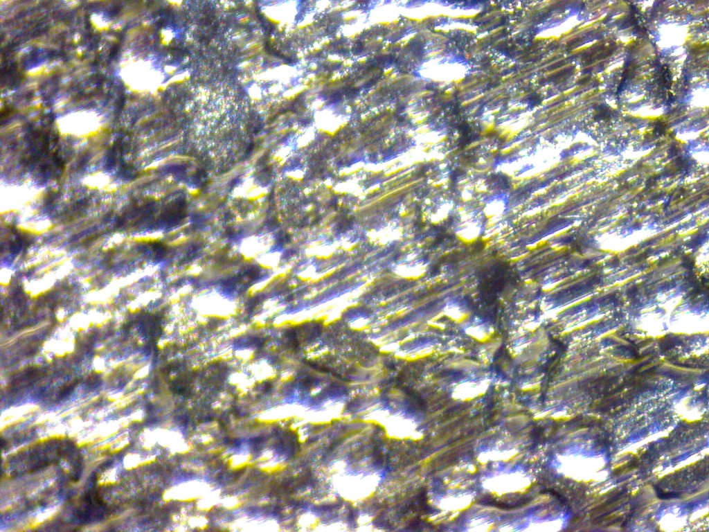 Microscopic close-up of mild steel sheet metal.